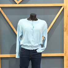 Load image into Gallery viewer, Light blue long-sleeve shirt and dark jeans on a mannequin against a geometric wall.
