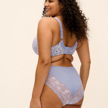 Load image into Gallery viewer, A woman modeling a light blue lingerie set with a lace bra and matching high-waisted briefs against a plain cream background.
