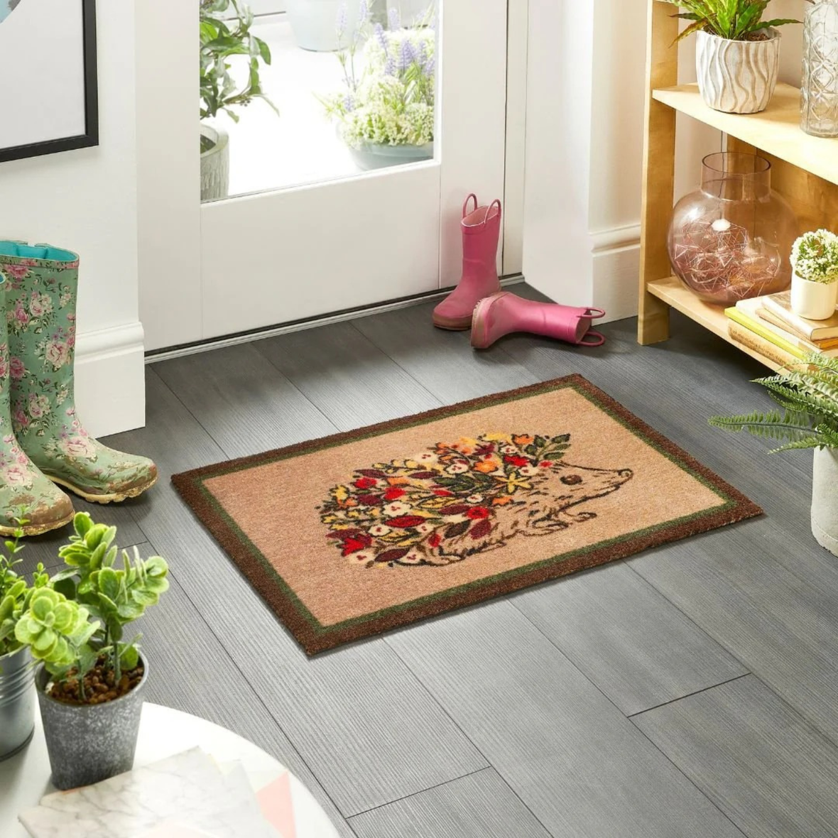 Image of My Mat Floral Hedgehog showcased on a hallway floor surrounded by boots.