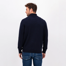 Load image into Gallery viewer, Photo of a model with his back to the camera wearing the navy polo neck from Fynch Hatton and blue jeans 
