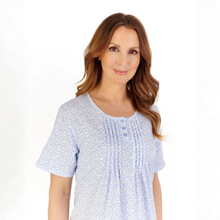Load image into Gallery viewer, Woman wearing a light blue patterned dress on a white background
