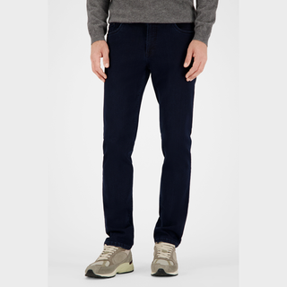 Person wearing navy pants and a gray sweater on a white background