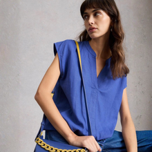 Load image into Gallery viewer, Low front  View of Model wearing the White Stuff Nicole Linen Blend Top in Bright Blue, with a grey background.
