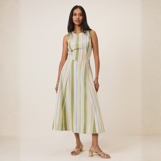 Woman wearing a striped dress on a plain background