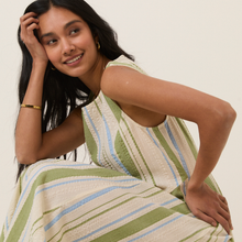 Load image into Gallery viewer, Woman wearing a patterned dress against a plain background
