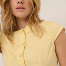 Load image into Gallery viewer, Close-up of a person wearing a yellow sleeveless top with buttons on a plain background
