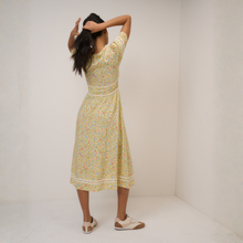Load image into Gallery viewer, Woman wearing a floral dress standing against a white background
