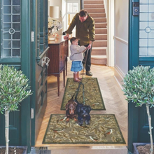 Load image into Gallery viewer, Man and child with two dogs on patterned rugs in a home setting
