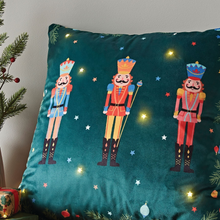 Load image into Gallery viewer, Decorative pillow with nutcracker design on a teal background
