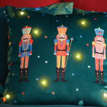 Load image into Gallery viewer, Decorative pillow with nutcracker design on a dark green background

