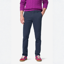 Load image into Gallery viewer, A person wearing navy blue slim-fit chinos, a magenta cable-knit sweater, and pink sneakers, shown from the chest down against a plain white studio background.
