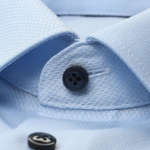 Load image into Gallery viewer, Close-up of a light blue shirt with a button and cuff detail
