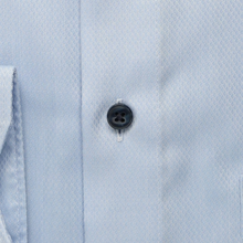 Load image into Gallery viewer, Close-up of a light blue shirt with a button and collar detail
