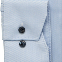 Load image into Gallery viewer, Light blue dress shirt with black buttons on a white background
