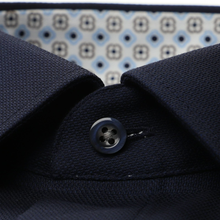Load image into Gallery viewer, Close-up of a navy blue fabric with a button, patterned background
