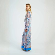 Load image into Gallery viewer, Woman wearing a long, patterned dress on a white background
