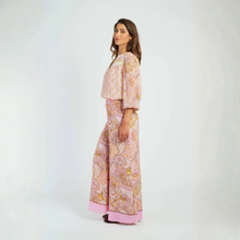Load image into Gallery viewer, Woman wearing a pink patterned dress on a white background
