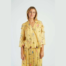 Load image into Gallery viewer, Woman wearing a yellow floral dress against a white background
