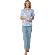 Load image into Gallery viewer, Woman wearing a patterned top and light blue pants on a white background
