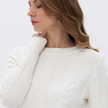 Load image into Gallery viewer, A close-up of a woman wearing a white cable-knit sweater against a plain white background.
