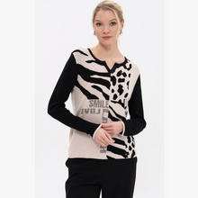 Load image into Gallery viewer, Woman wearing a black and white patterned sweater with text on a white background
