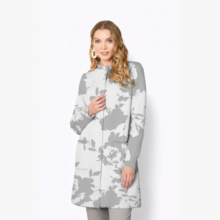 Woman wearing a gray and white floral patterned coat on a white background