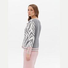 Load image into Gallery viewer, side view of jumper on model with pink skirt 
