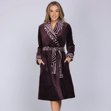 Load image into Gallery viewer, A woman modeling a plush bathrobe in deep plum purple with white and purple striped patterns on the collar, cuffs, and belt, set against a solid light gray background.

