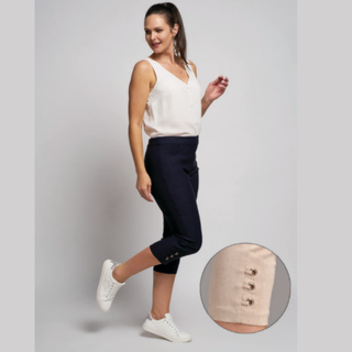 Model posing while wearing the Pinns Bengaline Crop Trouser with Diamond Eyelets at Hem in the colour Denim, with a grey to white gradient background.