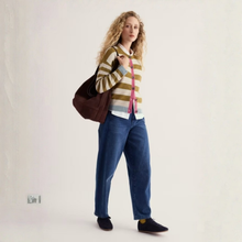 Load image into Gallery viewer, Woman with striped cardigan and jeans on bright background 
