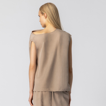 Load image into Gallery viewer, Woman wearing a beige sleeveless top and pants on a light gray background
