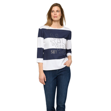 Load image into Gallery viewer, Posing Model wearing Rabe 3/4 Sleeve Navy &amp; White Top, with a white background.
