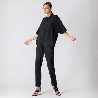 Woman wearing a black outfit on a white background