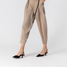 Load image into Gallery viewer, Person wearing beige pants and black shoes on a white background
