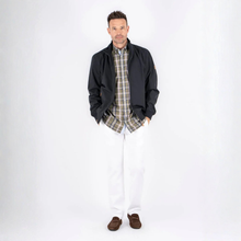 Load image into Gallery viewer, Man wearing a black jacket, plaid shirt, and white pants on a white background
