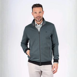 Man wearing a green jacket over a checkered shirt on a white background