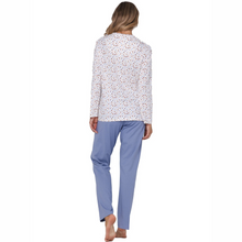 Load image into Gallery viewer, Woman wearing a white patterned top and blue pants on a white background
