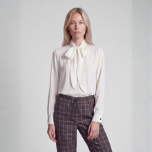 Load image into Gallery viewer, Front view of model in bow tie blouse and check pants 
