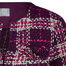 Load image into Gallery viewer, Close-up of a patterned fabric with a brand label on a purple background
