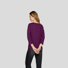 Load image into Gallery viewer, Woman wearing a purple sweater on a light gray background
