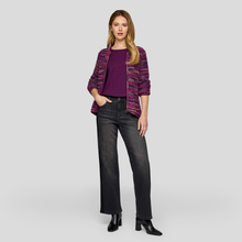 Load image into Gallery viewer, Woman wearing a purple sweater and black jeans on a gray background
