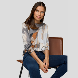Lady in Print Jumper and Jeans on Grey background 
