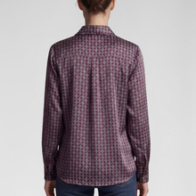 Load image into Gallery viewer, A woman viewed from the back wearing a long-sleeve collared button-up shirt with a repeating geometric pattern in dark purple and burgundy, paired with dark blue jeans against a light gray studio background.
