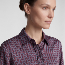 Load image into Gallery viewer, Close-up of a woman wearing a collared button-up shirt with a dense geometric medallion pattern in burgundy, navy, and white.
