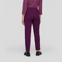 Load image into Gallery viewer, Purple pants worn by a person on a light gray background
