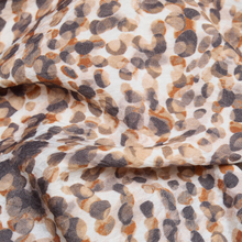 Load image into Gallery viewer, Close up of material of the Rabe Print V-Neck Top in Grey with a white background.
