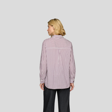 Load image into Gallery viewer, Woman wearing a striped shirt and black pants on a light gray background
