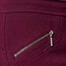 Load image into Gallery viewer, Close-up of a deep magenta or burgundy fabric surface with a diagonal zippered pocket and a silver metal zipper pull.
