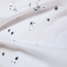 Load image into Gallery viewer, Close-up of a white fabric with dark specks on a light background
