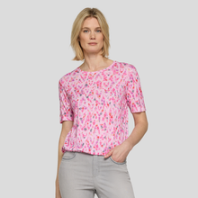 Load image into Gallery viewer, Woman wearing a pink floral blouse against a plain background
